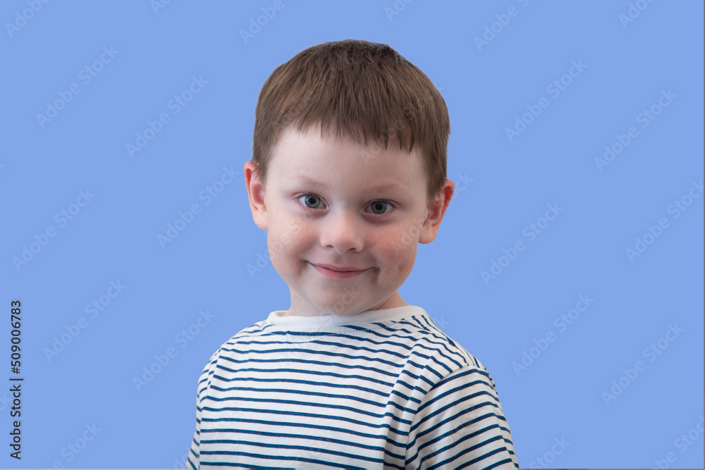 Portrait of a boy on a blue background. Cheerful teenager, shining eyes. Portrait of a boy on a blue background. Cheerful teenager, shining eyes.