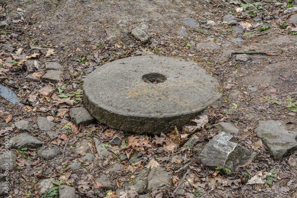 Photo of a large stone millstone from the mill . Photo of a large stone millstone from the mill .