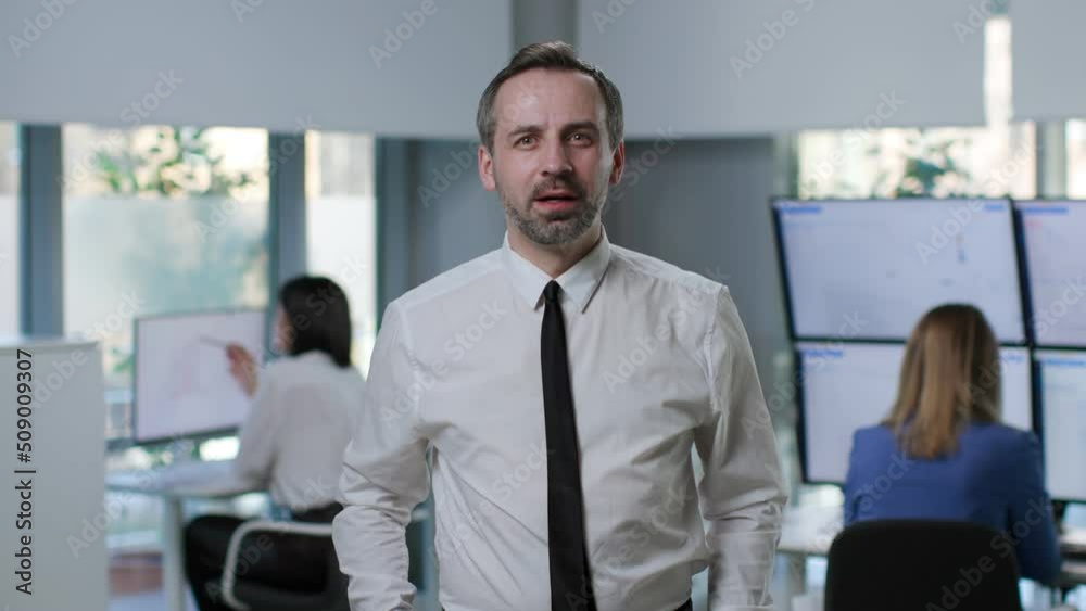 Excited mature trader looking at screen with financial data and smiling Excited mature trader looking at screen with financial data and smiling