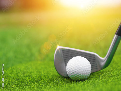 Golf club close up on green grass on blurred beautiful landscape of golf background.Concept international sport that rely on precision skills for health relaxation..