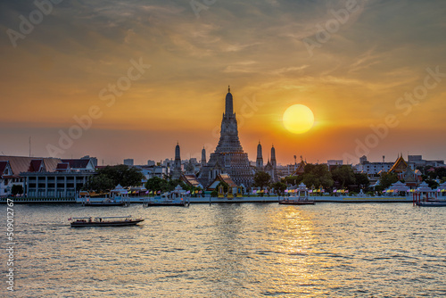 Sunset at Wat Arun Ratchawararam.beautiful of radiations of the sun set reflection Chao Praya river, Bangkok, Thailand's landmarks