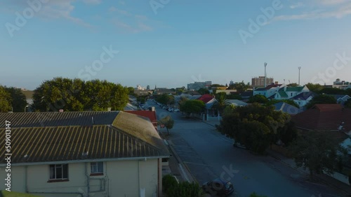 Low flight above roofs in residential borough. Low family houses along streets. Port Elisabeth, South Africa