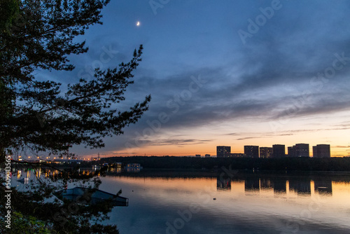 Buildings next to the river at sunset