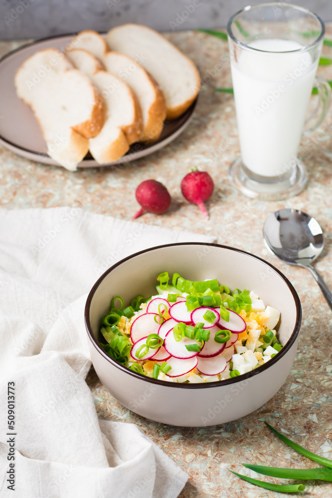 Chopped ingredients for okroshka in a bowl on the table. Vertical view Chopped ingredients for okroshka in a bowl on the table. Vertical view