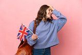 Little girl holding an United Kingdom flag isolated on pink background has realized something and intending the solution