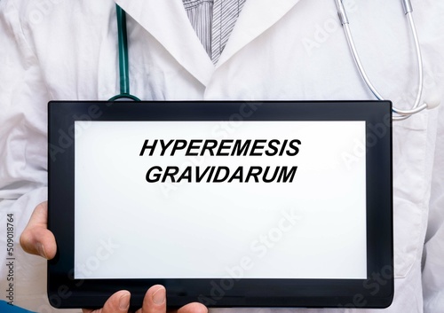 Hyperemesis Gravidarum.  Doctor with rare or orphan disease text on tablet screen Hyperemesis Gravidarum photo