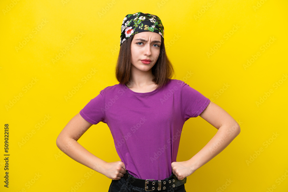 Young Ukrainian woman isolated on yellow background angry