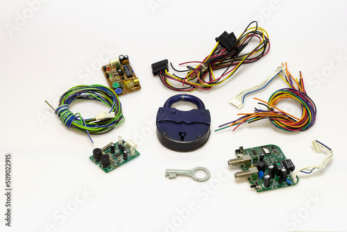 Printed circuit board with a set of chips, cables, connectors, remote controls, for design solutions and electronics elements, vertical photography, on a white milky background.