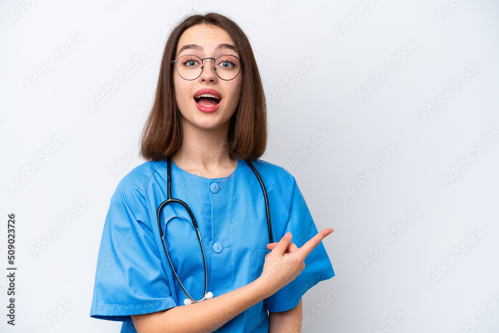 Young nurse Ukrainian woman isolated on white background surprised and pointing side Young nurse Ukrainian woman isolated on white background surprised and pointing side