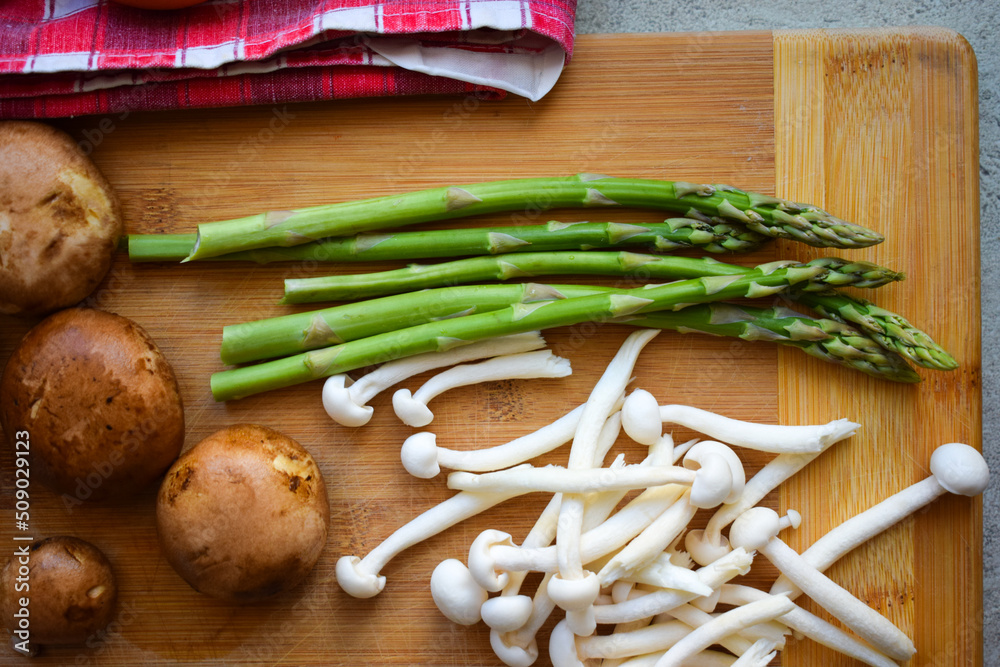 Mushrooms, asparagus and bacon cut on a wooden board. Mushrooms, asparagus and bacon cut on a wooden board.