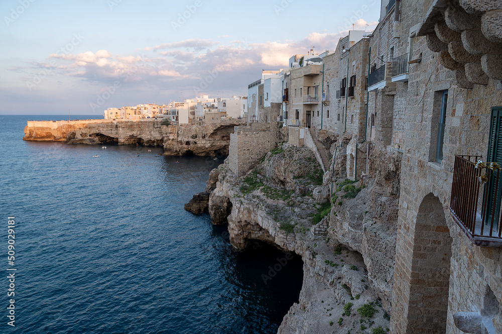 Polignano a mare, Puglia, Italy. August 2021. Amazing view of the village overlooking the sea with the sheer cliff.  Copy space.