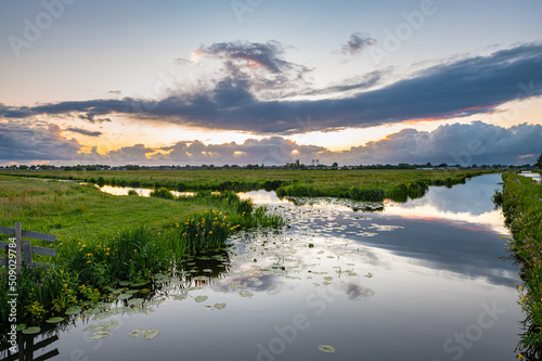 Fotótapéta Beautiful clouds and calm water in the Dutch polder landscape at sunset