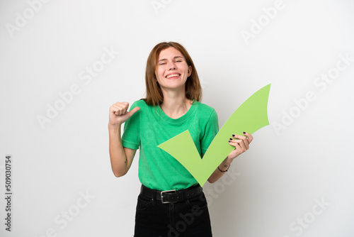 Young English woman isolated on white background holding a check icon with proud gesture