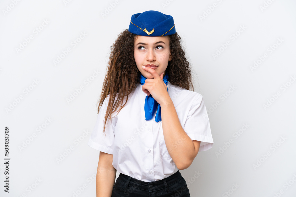 Airplane stewardess Arab woman isolated on white background having doubts and with confuse face expression Airplane stewardess Arab woman isolated on white background having doubts and with confuse face expression