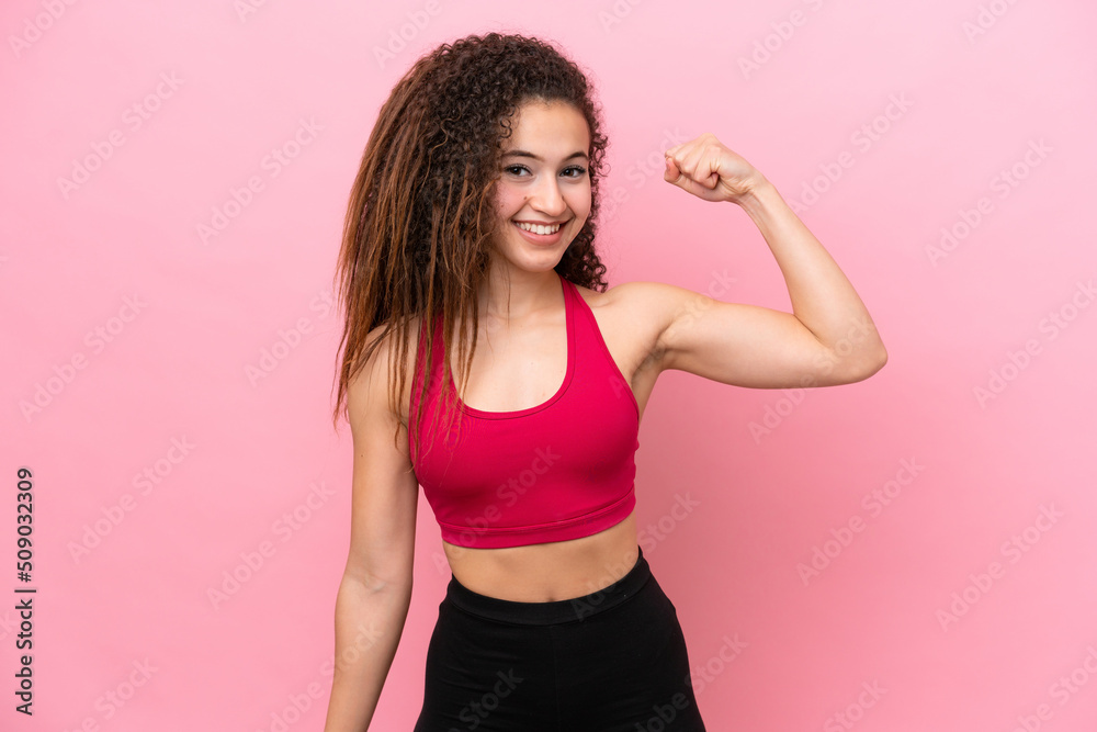 Young Sport Arab woman isolated on pink background