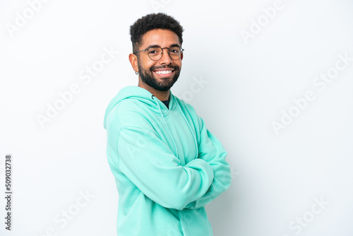 Young Brazilian man isolated on white background with arms crossed and looking forward