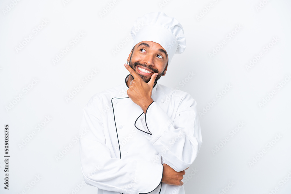 Young Brazilian chef man isolated on white background smiling Young Brazilian chef man isolated on white background smiling