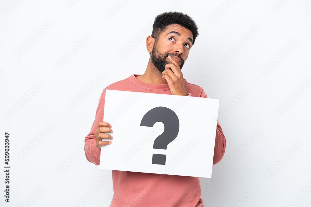 Young Brazilian man isolated on white background holding a placard with ...