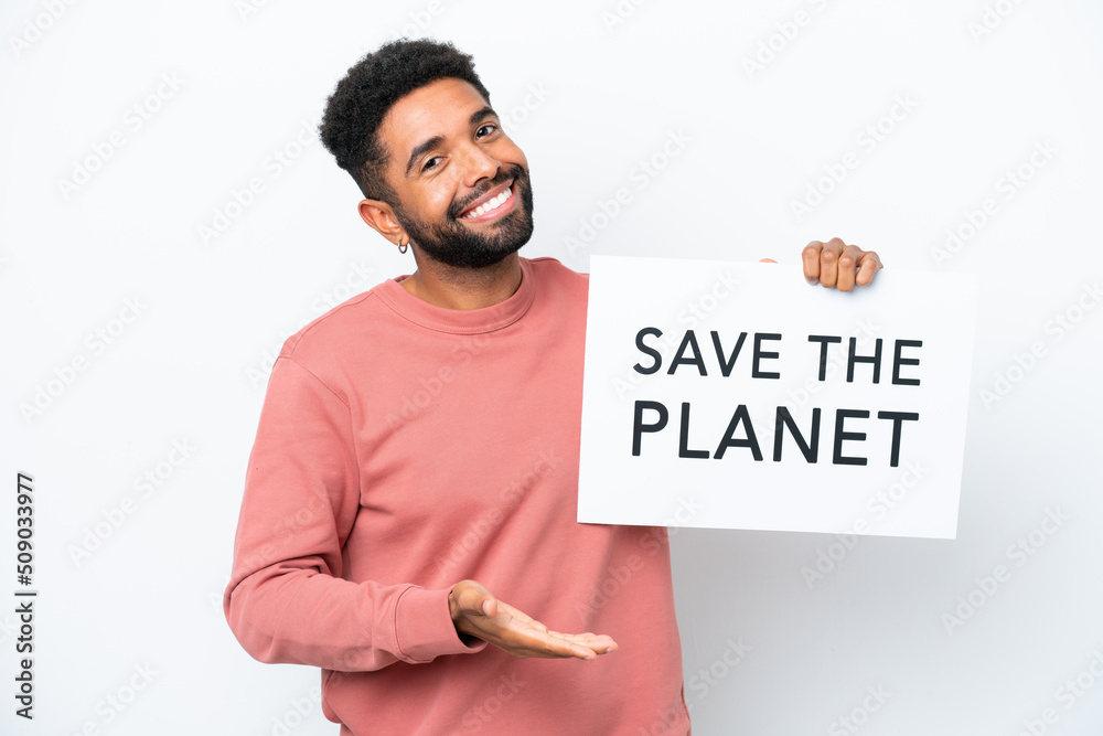 Young Brazilian man isolated on white background holding a placard with text Save the Planet making a deal Young Brazilian man isolated on white background holding a placard with text Save the Planet making a deal