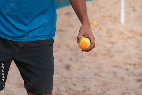 Beach tennis ball in hand © JBLostada