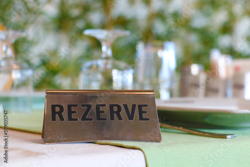 A specially reserved dining table for the customer in a restaurant intertwined with nature. reservation letter