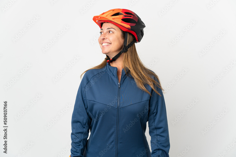 Middle age cyclist woman isolated on white background looking side Middle age cyclist woman isolated on white background looking side
