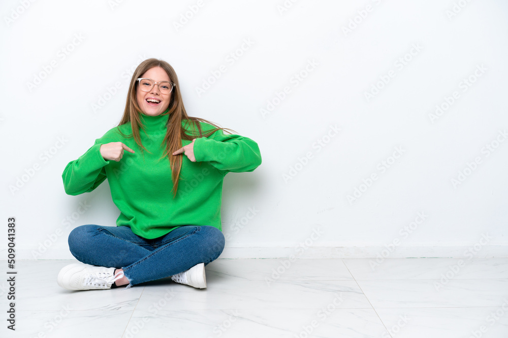 Young caucasian woman sitting on the floor isolated on white background with surprise facial expression Young caucasian woman sitting on the floor isolated on white background with surprise facial expression