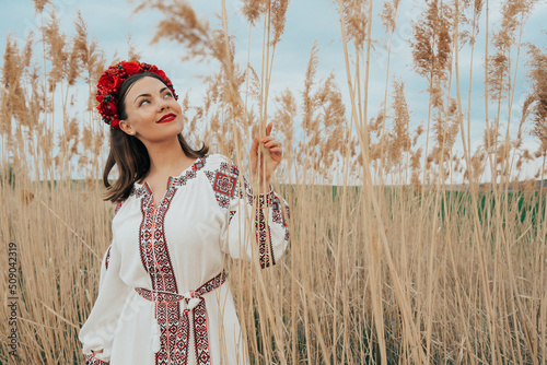 Ukrainian woman in embroidery vyshivanka dress on nature background. photo