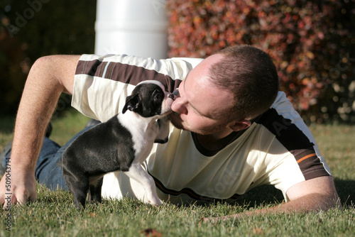 man playing with puppy