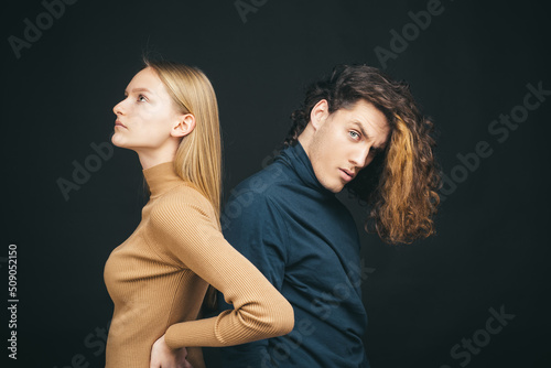 Youth, love and lifestyle concept. Couple of man with curly hair and blonde woman in hairdresser salon. Hairdresser or barber shop concept.