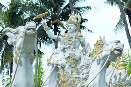 Low Angle Front View Krishna Chakra Statue With With Horses Statue In Park photo