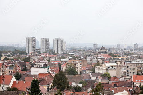 Skyline of New belgrade, or novi beograd, in Serbia, since from Zemun, with bruatlist residential skyscraper towers blurred due to autumn foggy rain. Novi beograd is the business district of Belgrade
