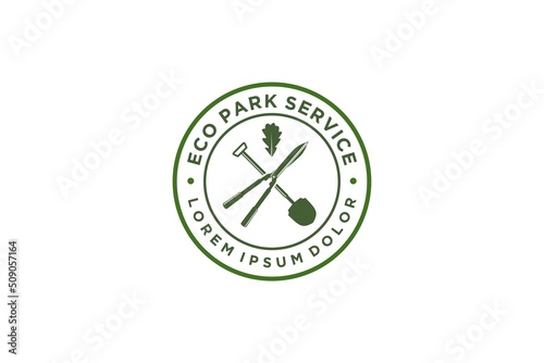 Home lawn and garden care service logo, with shovel and grass shears elements, with green oak leaf elements.