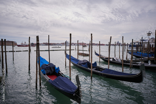 View from Piazza San Marco to Lagoon in Venice. Gondola tied on wooden pole Clouds over Venice © Rabanser