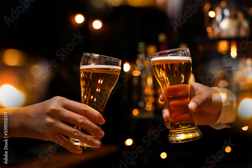 Fotobehang food and drink male friends are happy drinking beer and clinking glasses at a bar or pub