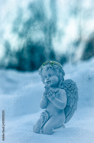 Fotobehang A close-up photograph of a ceramic angel.