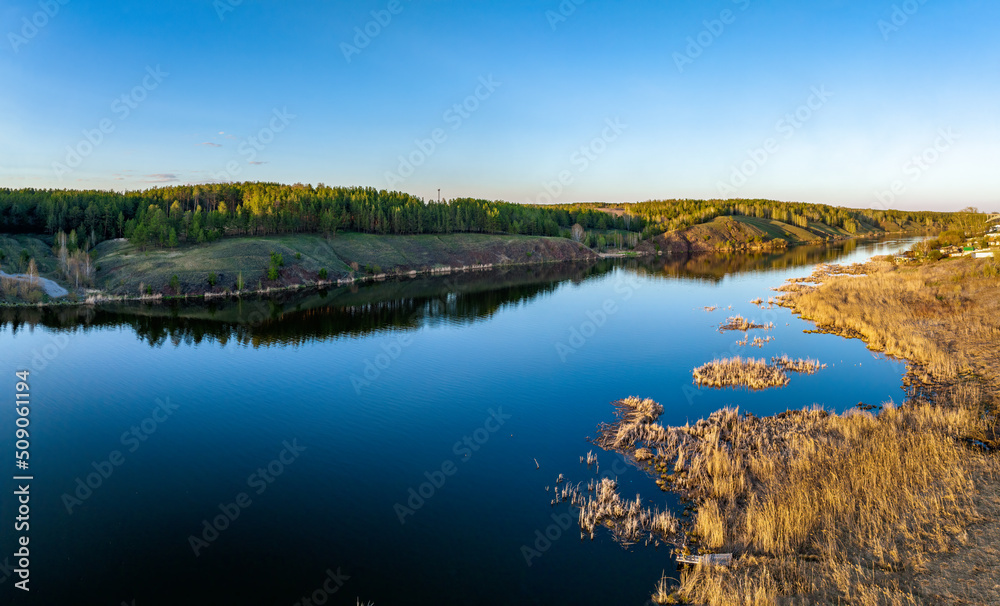 Beauriful sunset view along the Iset river and rocks near Kamensk-Uralskiy. A scenic sunset at the river. Kamensk-Uralskiy, Sverdlovsk region, Ural mountains, Russia. Aerial view