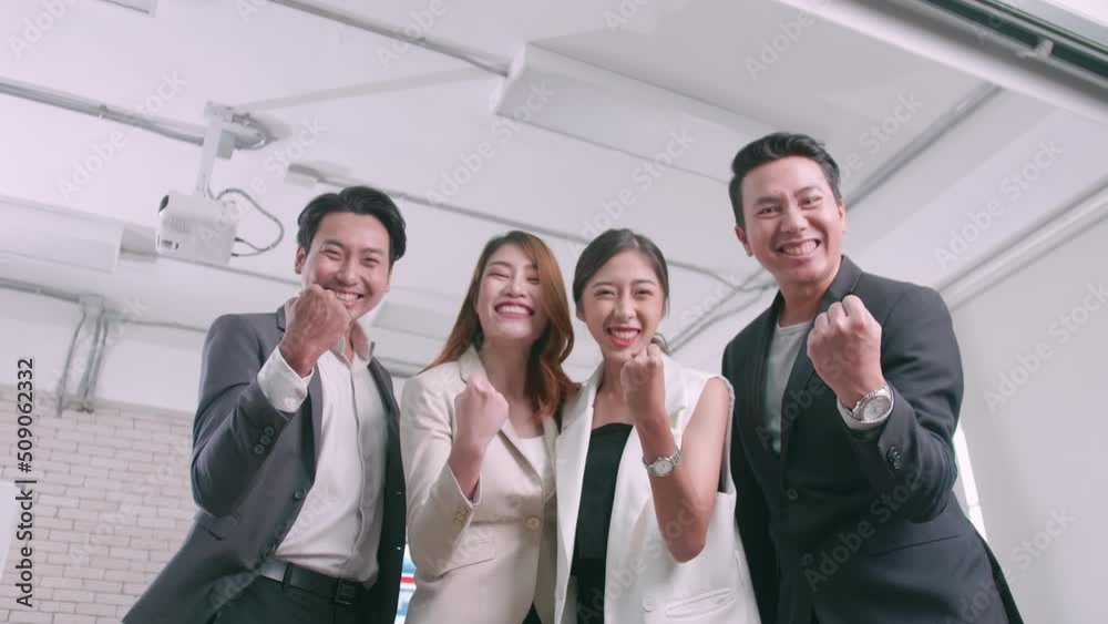 Asian business team celebrating success together in boardroom. Asian business team celebrating success together in boardroom.