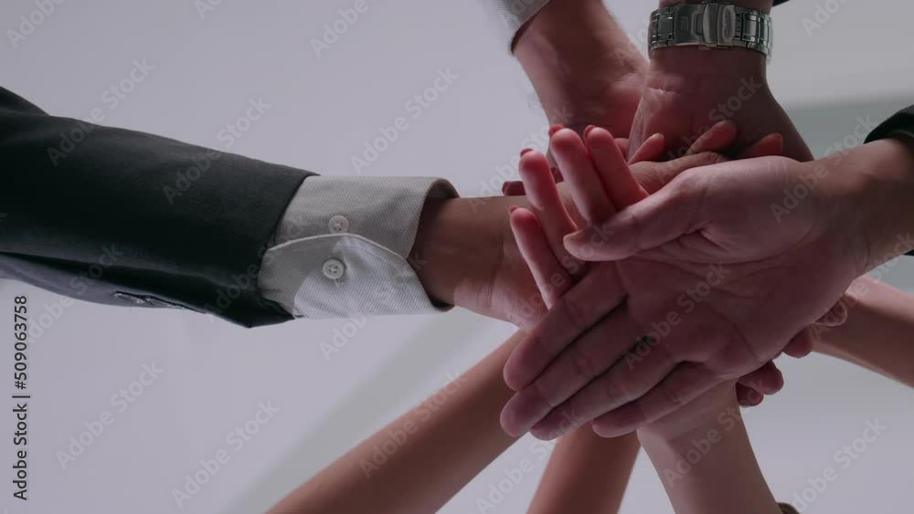 Business Team stack of hands for start up project. Close up of business people putting their hands together.