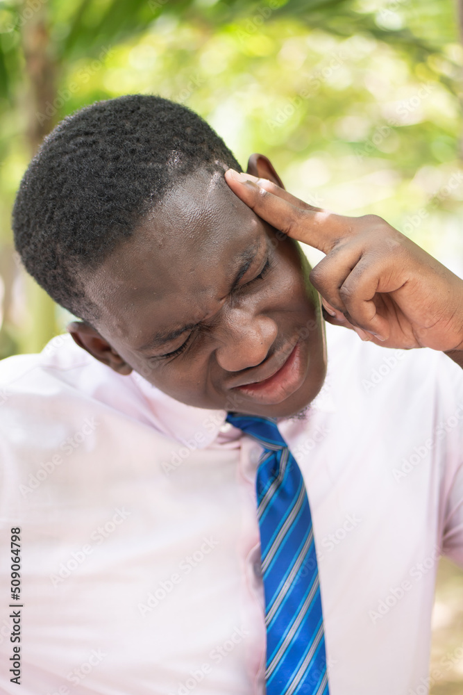 Ill African man office worker suffering from headache, health and sickness concept image for vertigo, dizziness, stress, depression, burnout, Alzheimer, brain cancer, memory loss, office syndrome Ill African man office worker suffering from headache, health and sickness concept image for vertigo, dizziness, stress, depression, burnout, Alzheimer, brain cancer, memory loss, office syndrome
