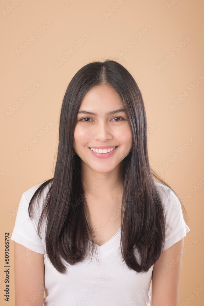 A Portrait of Asian woman with white T-shirt over Light brown background studio A Portrait of Asian woman with white T-shirt over Light brown background studio