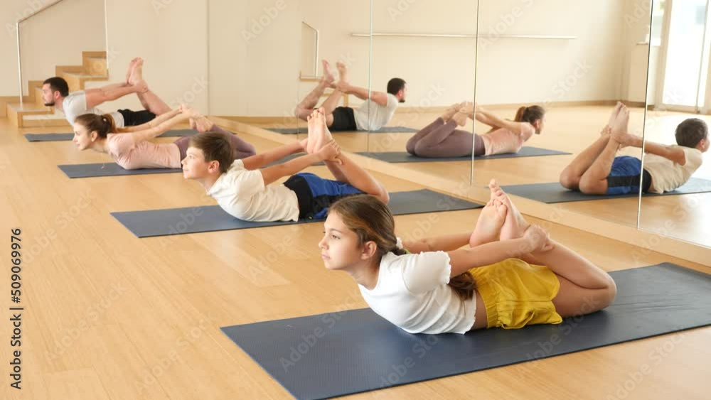 Sporty preteen girl practicing yoga positions during training ...