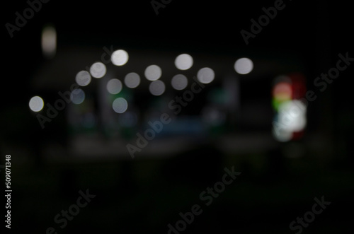 bokeh background of  street lamps and shop in the night out of focus