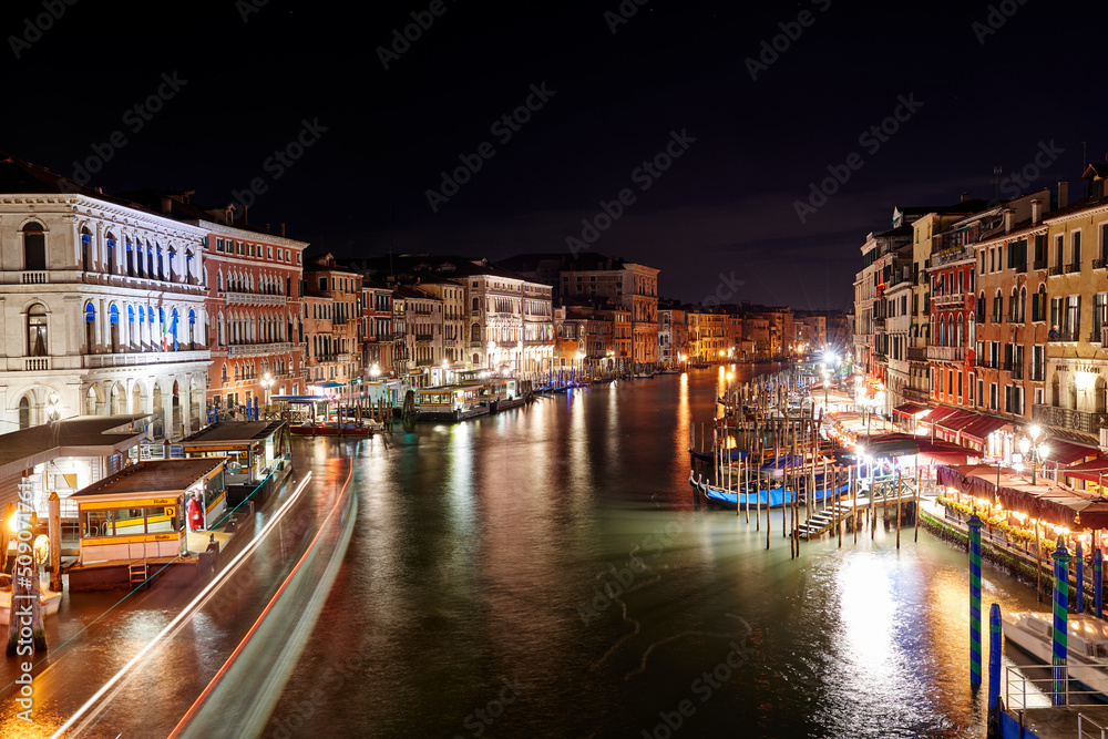 View from Rialto Bridge in Venice at night. Sightseeing in famous Italian City