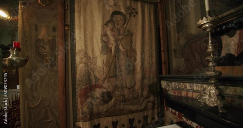 Slow motion and wide shot of an ancient and beautiful tapestry in a small chapel of a big church in Italy. The church is called Basilica di Desio photo
