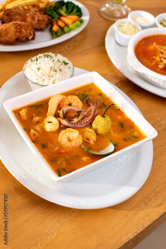 Costa Rican sea food soup with rice and other dishes side