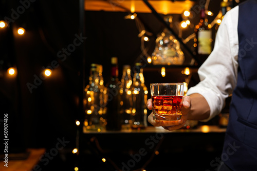 Bartender pouring Whiskey, on bar,