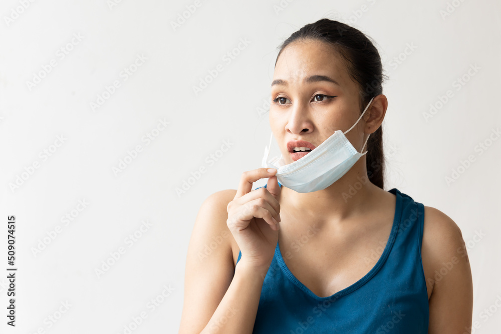 Frustrated woman taking off face mask Frustrated woman taking off face mask