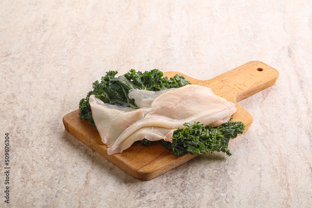 Raw squid over wooden board Raw squid over wooden board