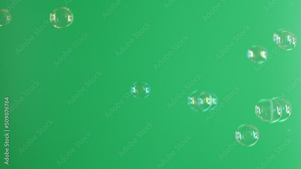 Slow motion of soap air bubbles texture on chroma key green screen background